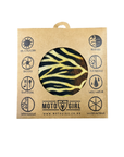 A square kraft paper packaging sleeve for a Moto Girl branded product, featuring a circular cutout that reveals a black and yellow zebra-patterned item inside. The packaging displays various product feature icons around the Moto Girl logo.