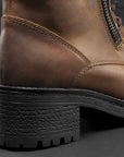 a heel of insides of brown leather women's motorcycle boots with shoe lens