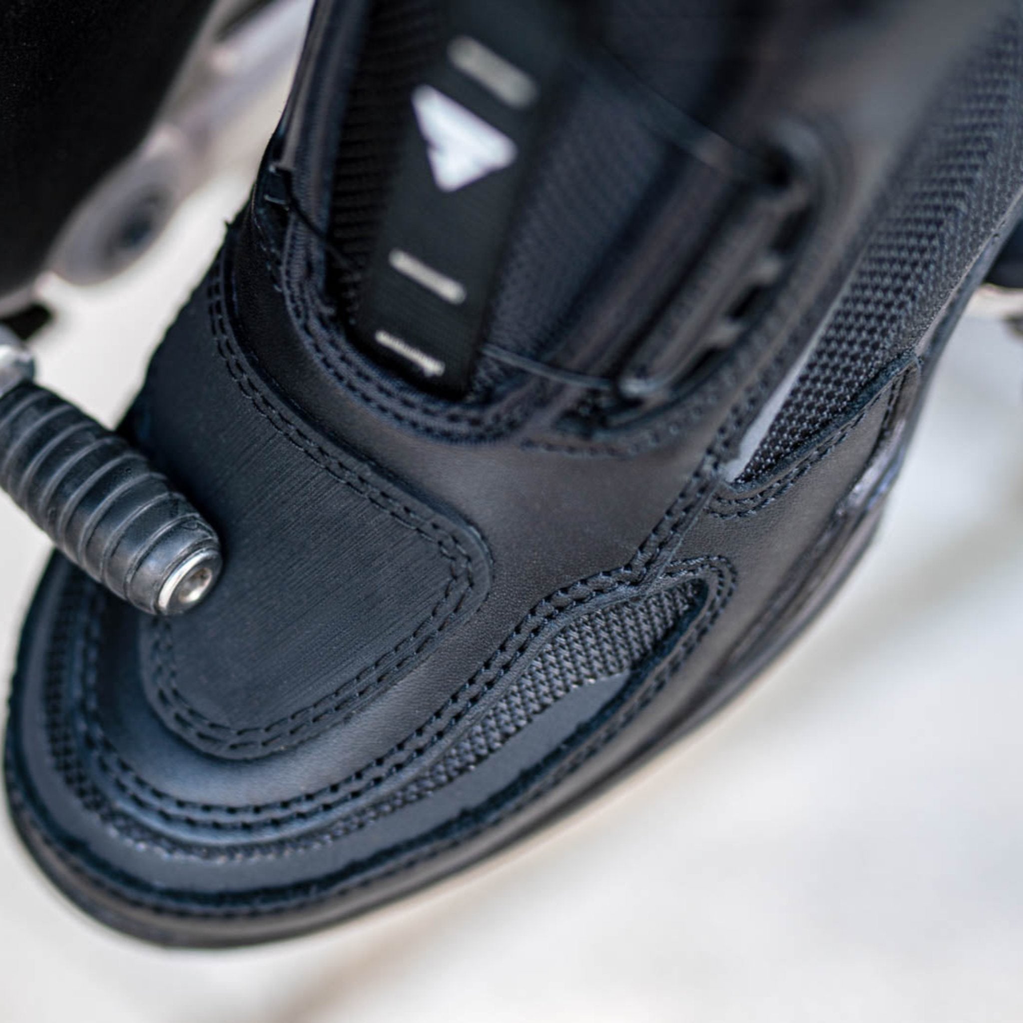 A close up of motorcycle boot changing gears