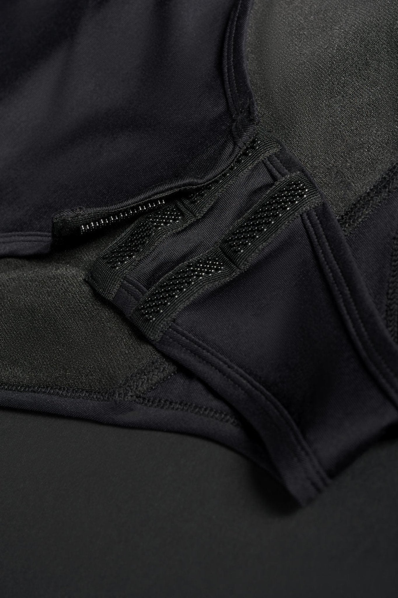 crotch closure on a black motorcycle body suit from Pando Moto