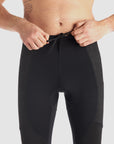 a man tying his black base layer leggings