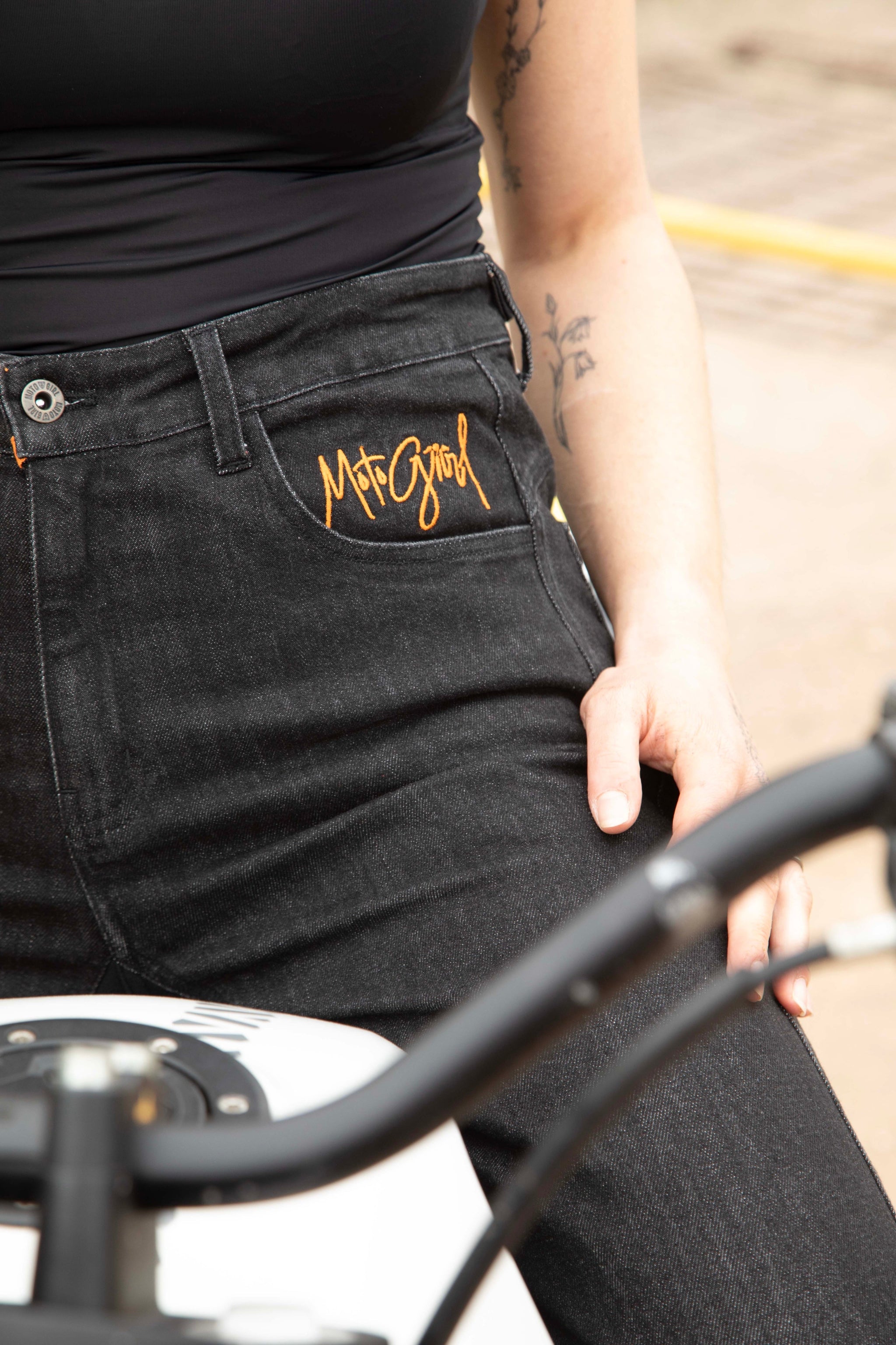 a close up of women's waist and jeans pocket with MotoGirl logo