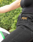 women's siting on a motorcycle  waist wearing black mc jeans with high waist
