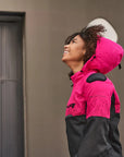 A young afroamerican woman wearing pink motorcycle jacket with the hood