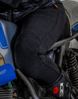 A leg of a woman siting on a motorcycle wearing black lady motorcycle leggings from MotoGirl
