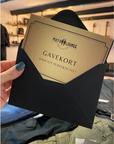 A woman's hand holding Moto Lounge gift card