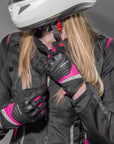 a woman zipping her jacket wearinh Black and pink women's motorcycle gloves Rush lady from Shima