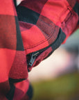 close up of sleeve with zipper detail on red and black flannel-style women's jacket from moto girl