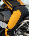 Woman sitting on motorcycle wearing Yellow Fiona Motorcycle Trousers from Moto Girl