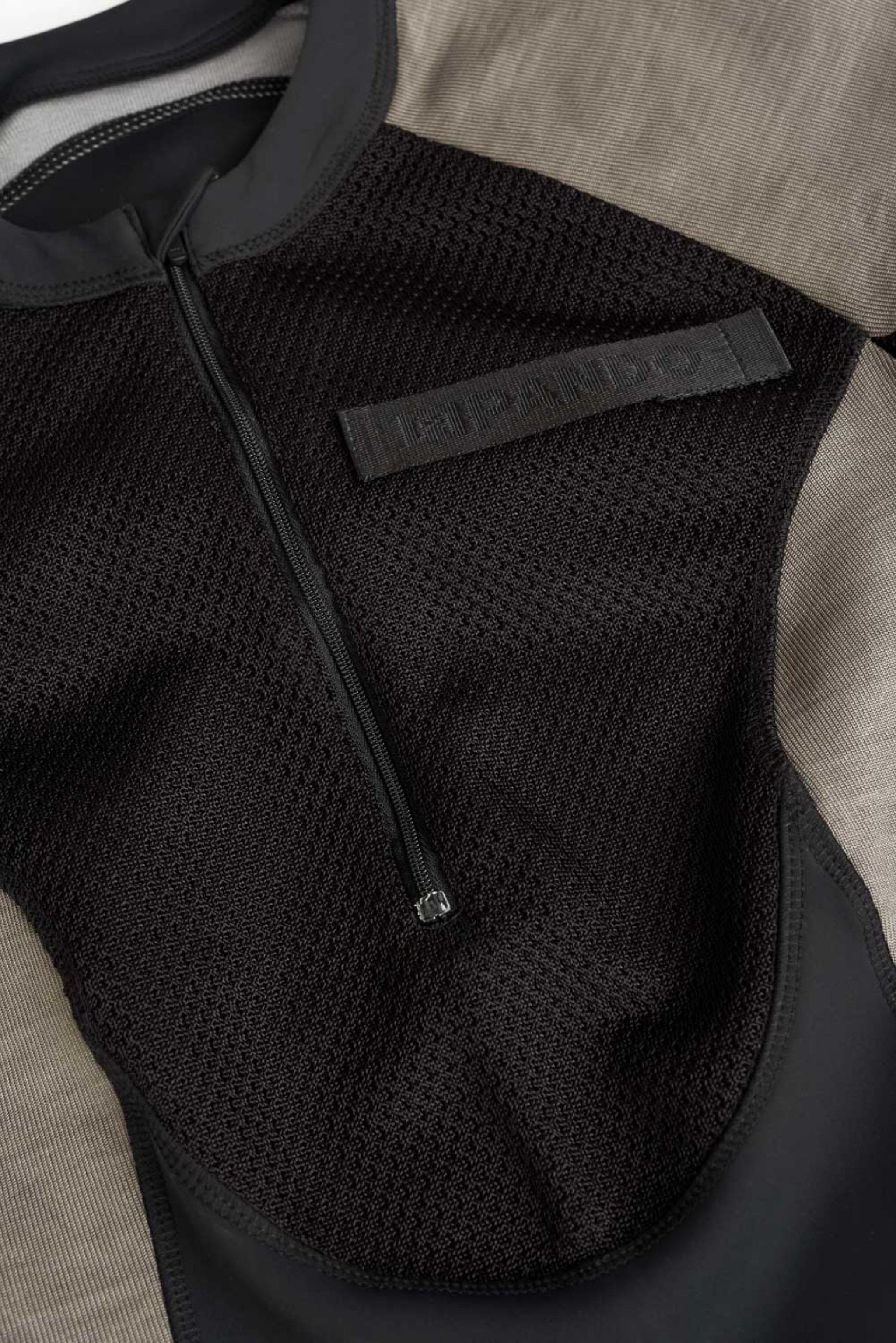 pando logo on a  Black and grey moto bodysuit 