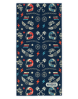 A rectangular navy blue towel featuring a repeating pattern of racing helmets, checkered flags, lightning bolts, stars, and crossed pistons. The bottom right corner has a white 'Moto Girl' brand label.