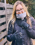 light haired woman in motorcycle gear wearing a light gray neck warmer from Moto Girl outside in nature