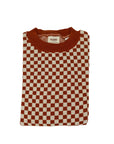 a knitted red and white jumper with chessboard motives from Wildust