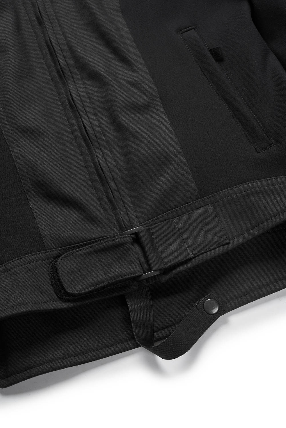 Close-up of a black coat with a belt on a white background