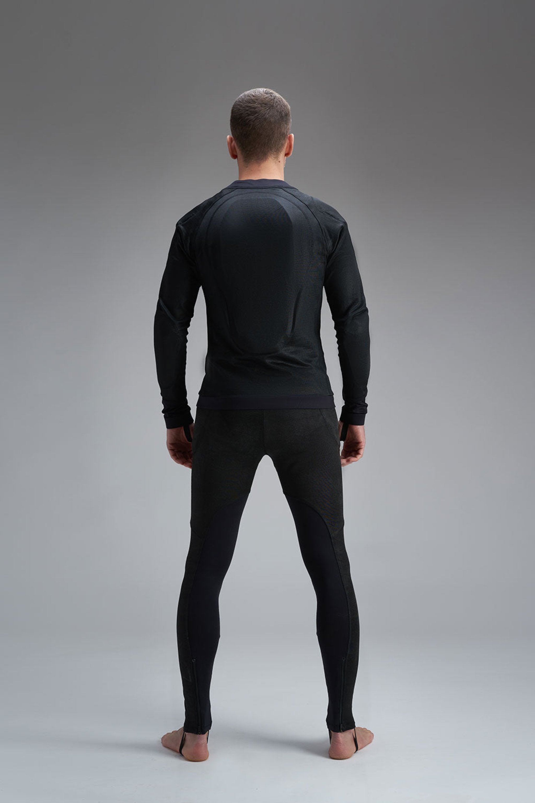 a back of a man wearing Pando Moto black base layer shirt and leggings 