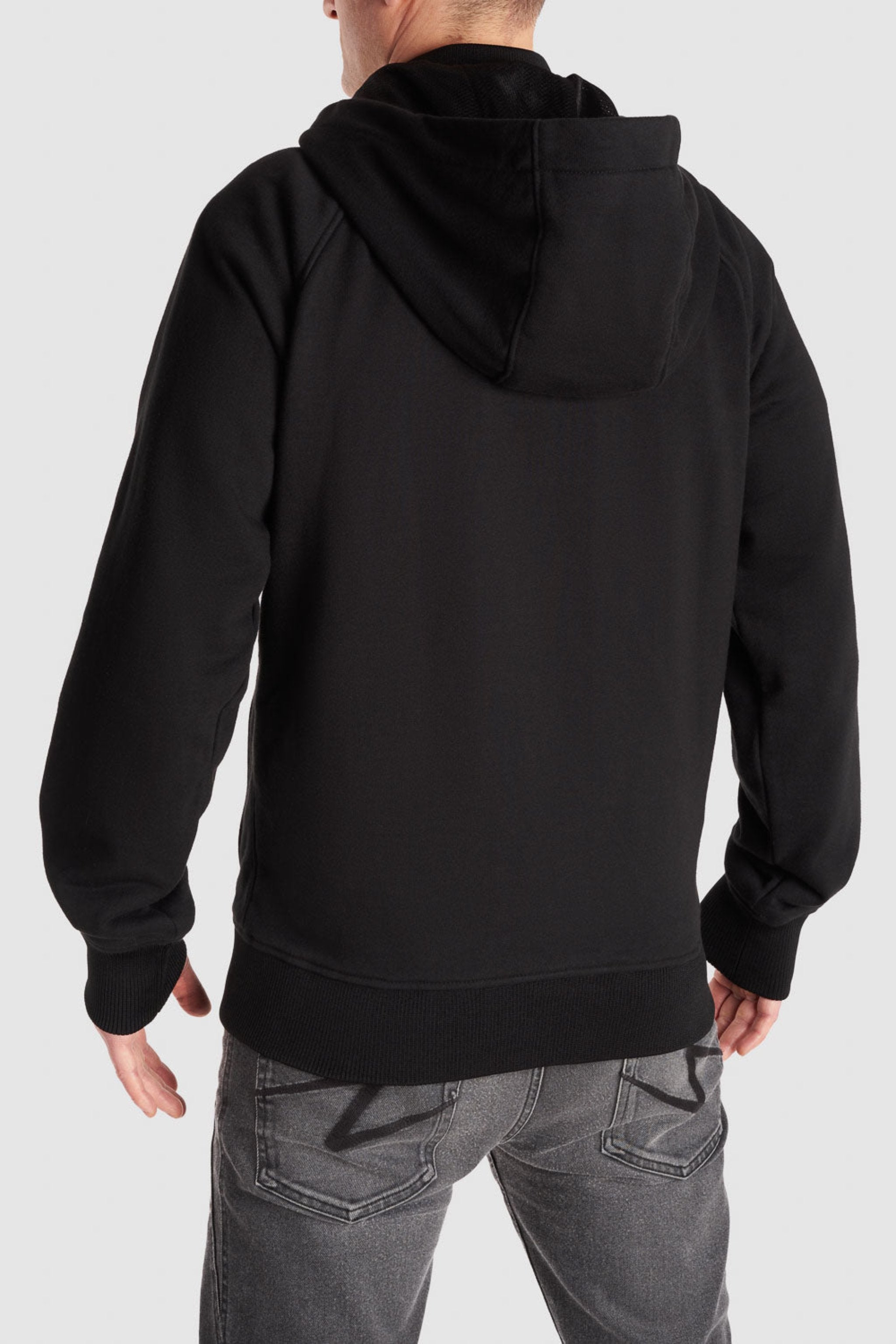 Man standing with his back showing, wearing a Black Motorcycle Hoodie from Pando Moto