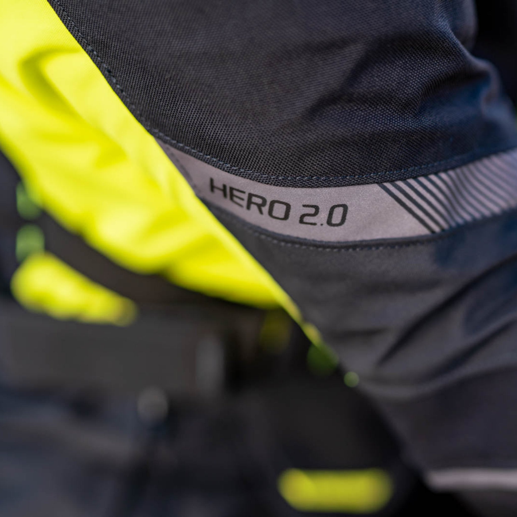 A close up of the HERO 2.0 reflective panel on the shima motorcycle touring jacket for women in black/ fluo