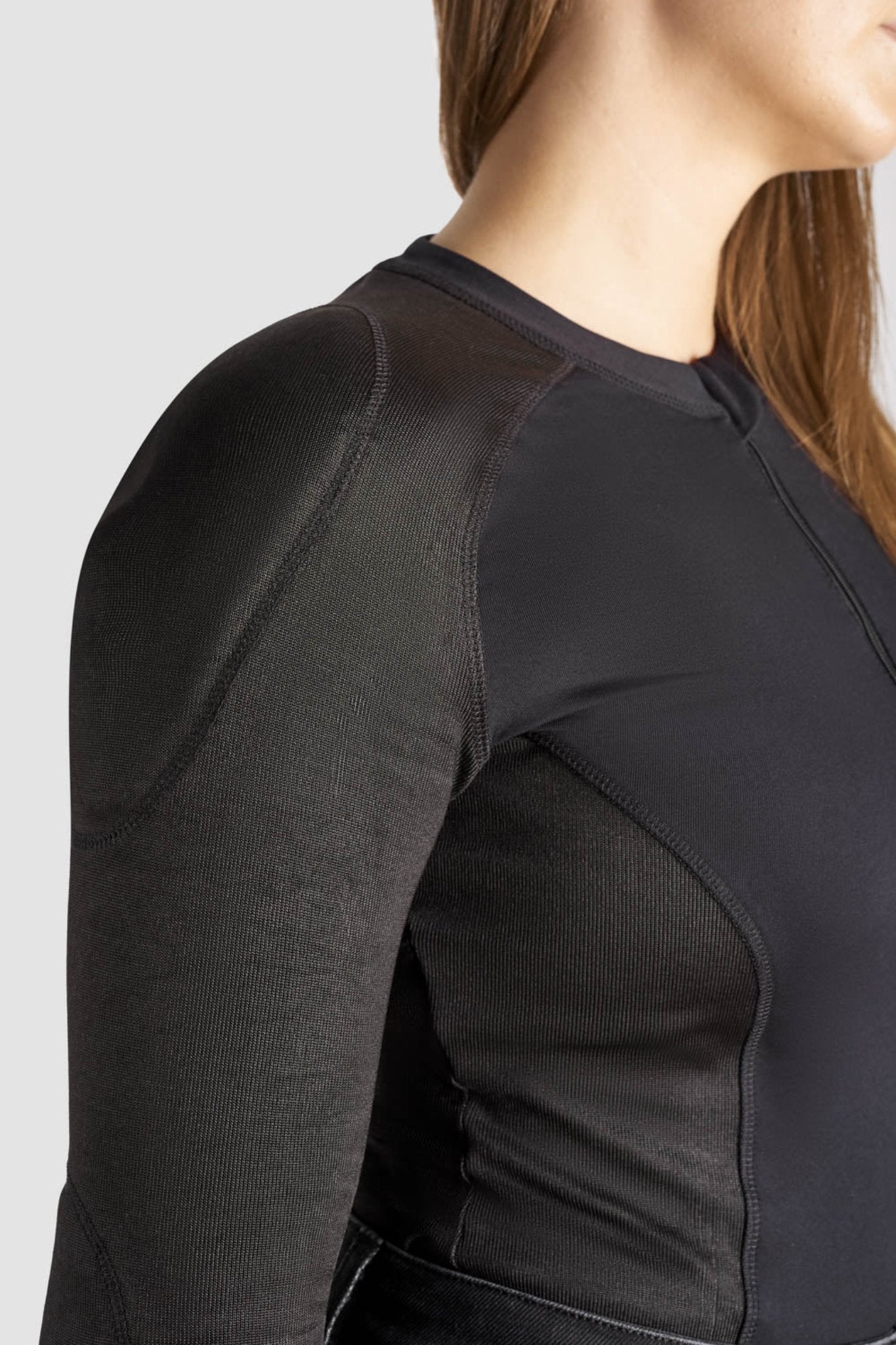 a close up of woman's shoulder wearing black motorcycle body suit from Pando Moto 