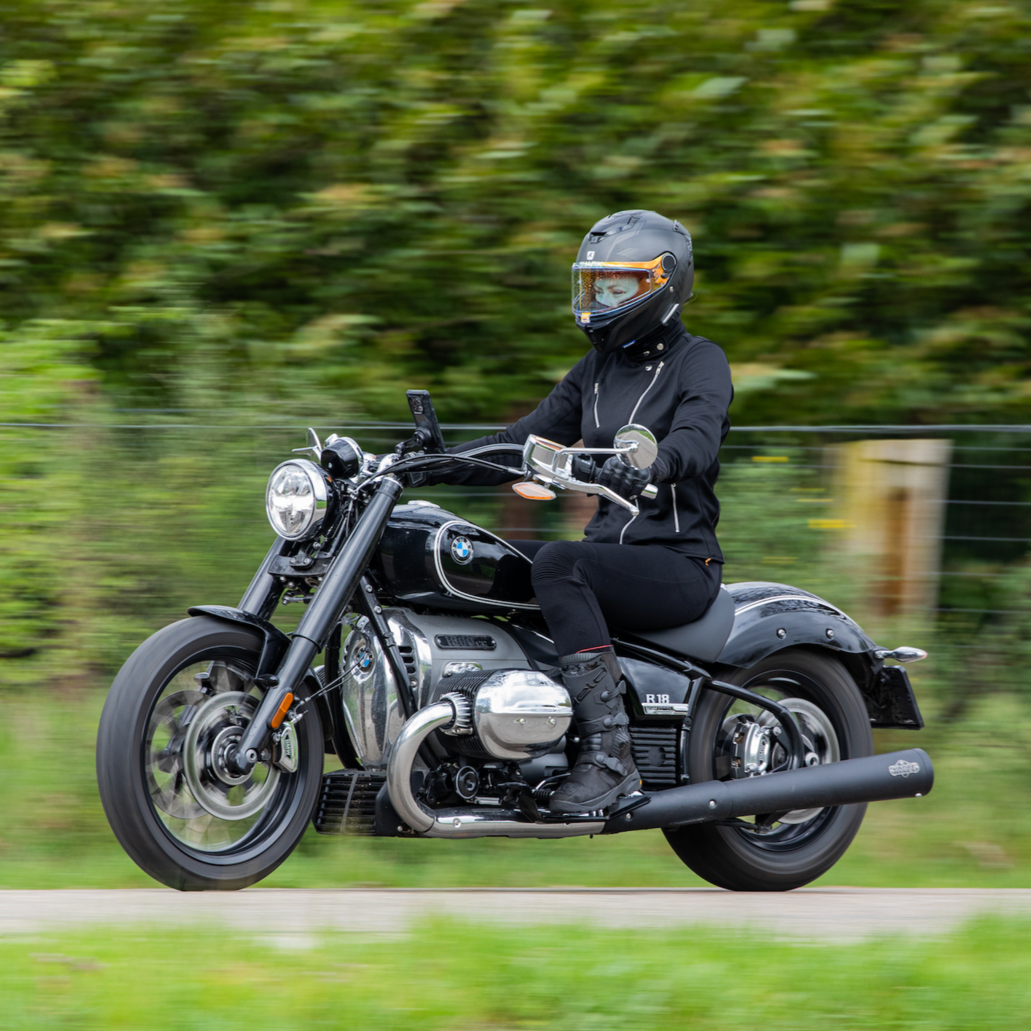 woman driving a motorcycle wearing Black retro style woman&#39;s motorcycle jacket with silver zip details