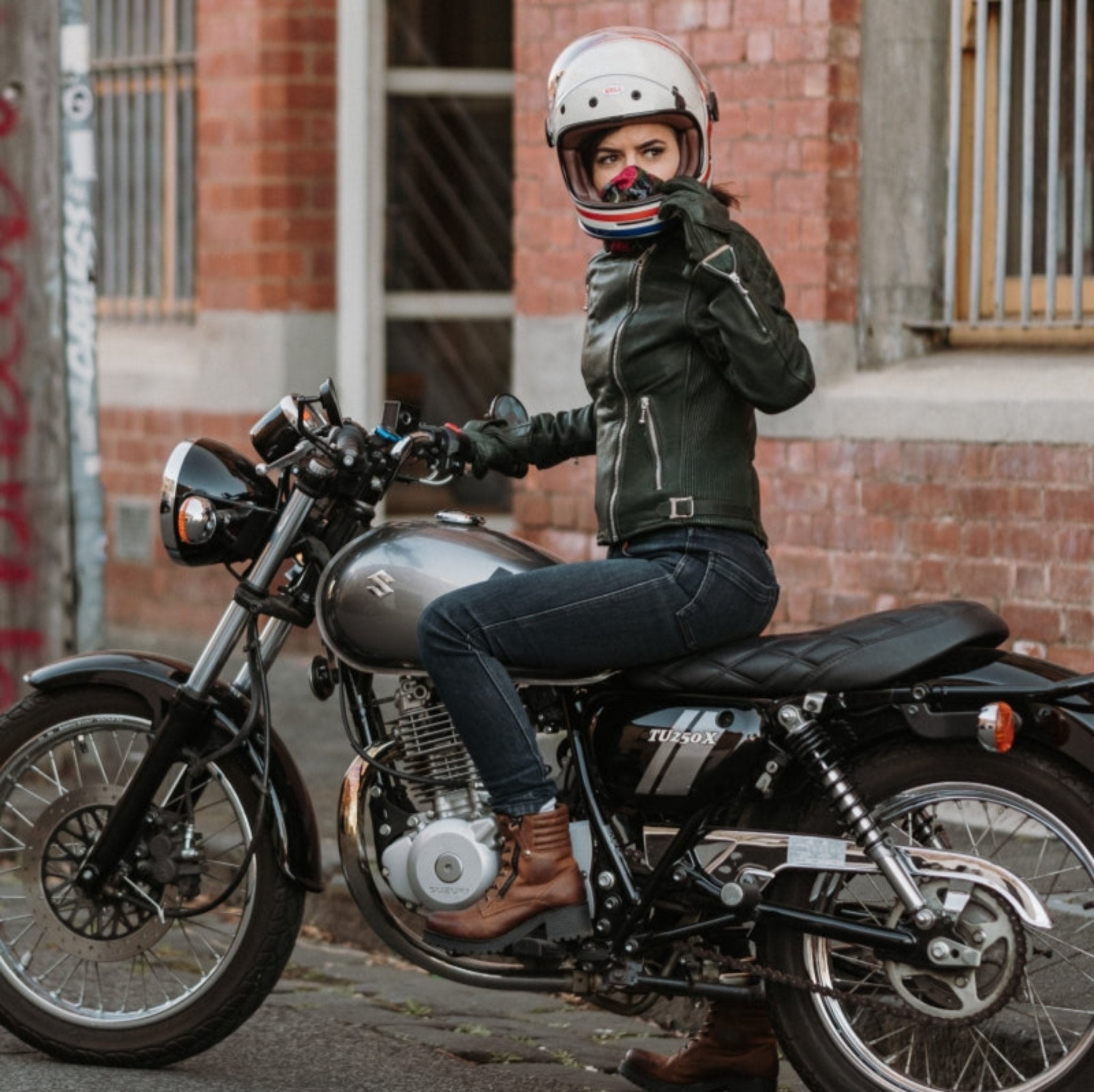 A woman on her motorcycle wearing brown leather mc shoes