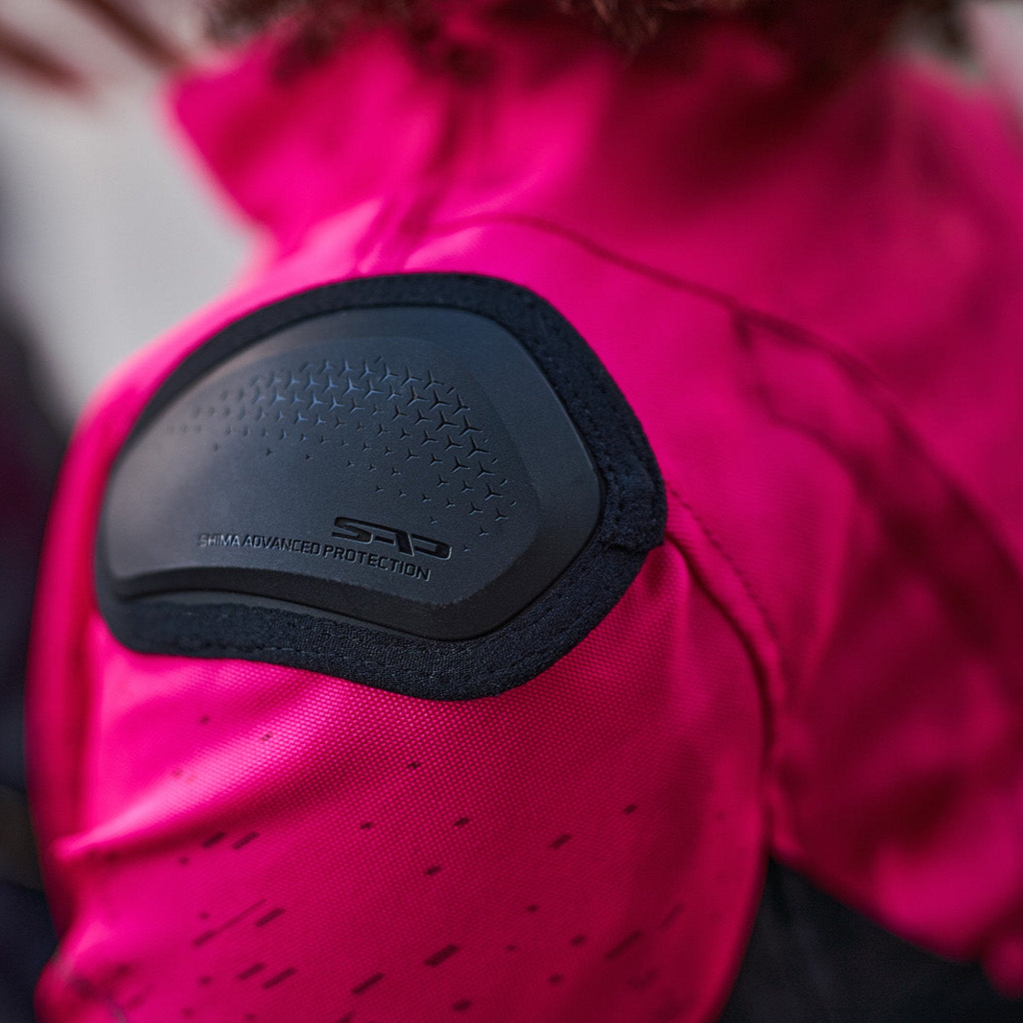 A close up of the slider on the pink DRIFT  motorcycle jacket from Shima