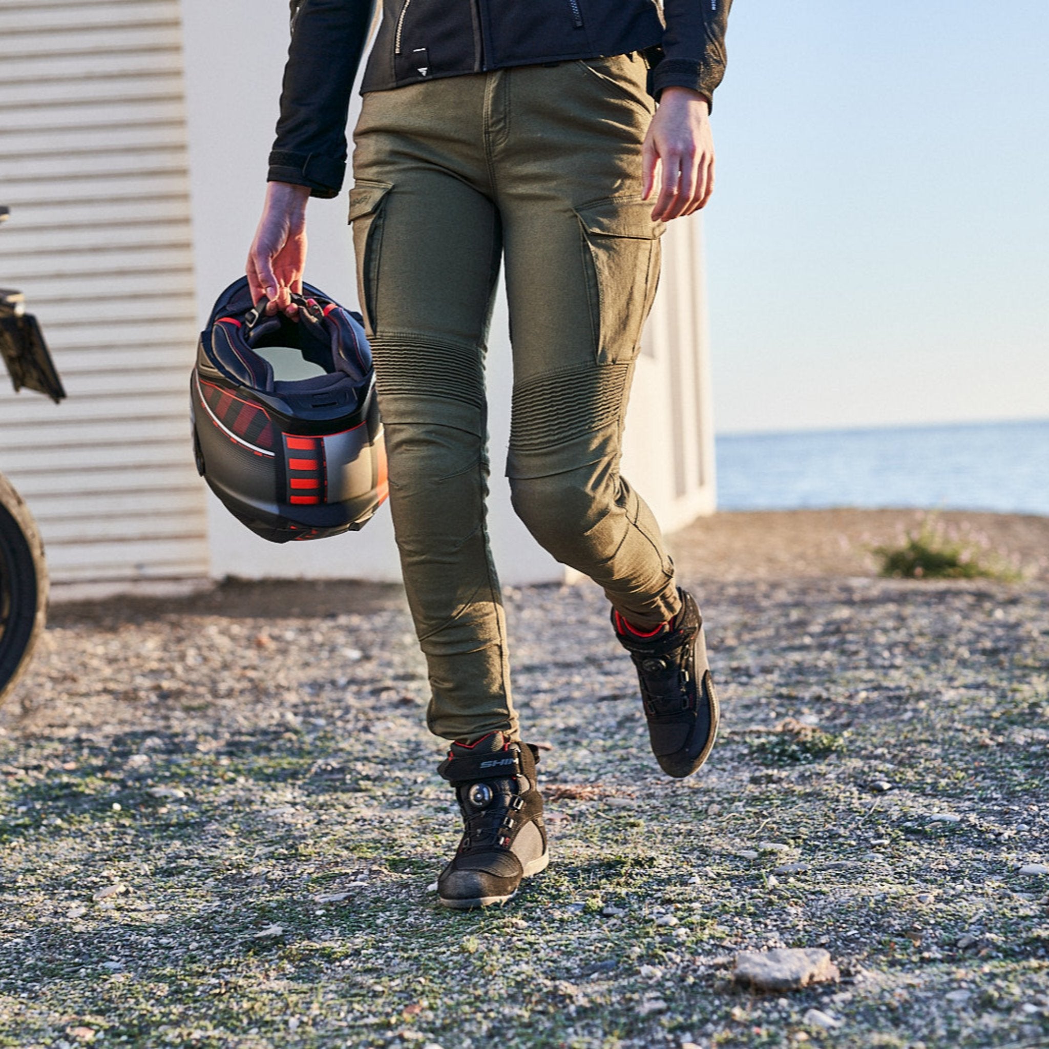 woman&#39;s legs wearing Khaki green women&#39;s motorcycle cargo pants GIRO from shima