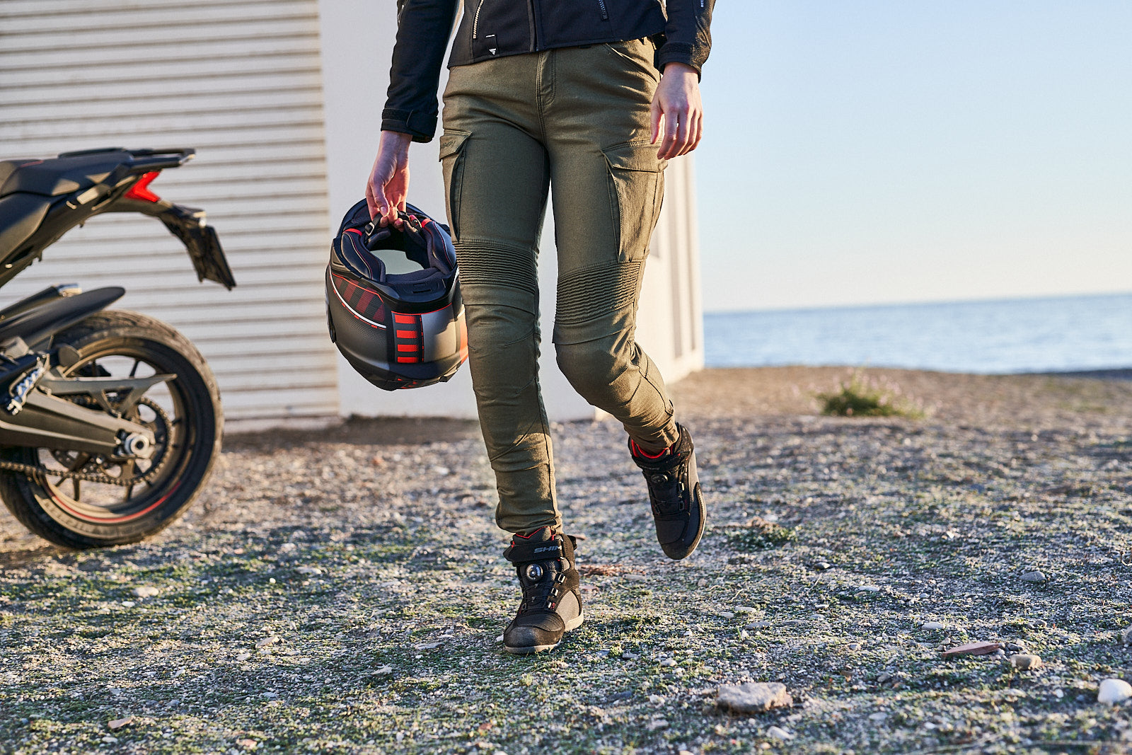 woman&#39;s legs wearing Khaki green women&#39;s motorcycle cargo pants GIRO from shima