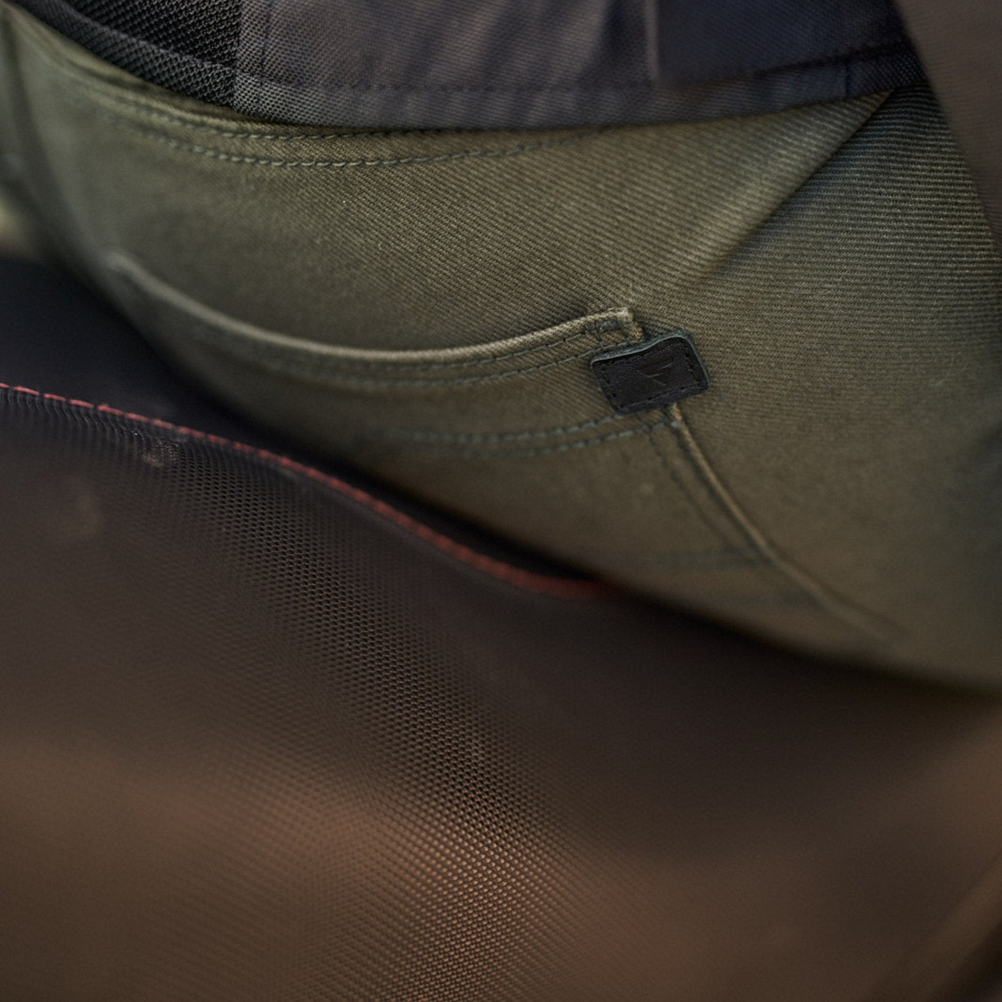 A close up of the back pocket of Khaki green women&#39;s motorcycle pants