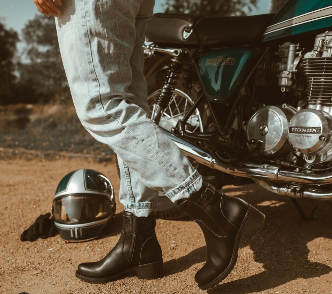 Woman wearing women&#39;s black leather motorcycle shoes 