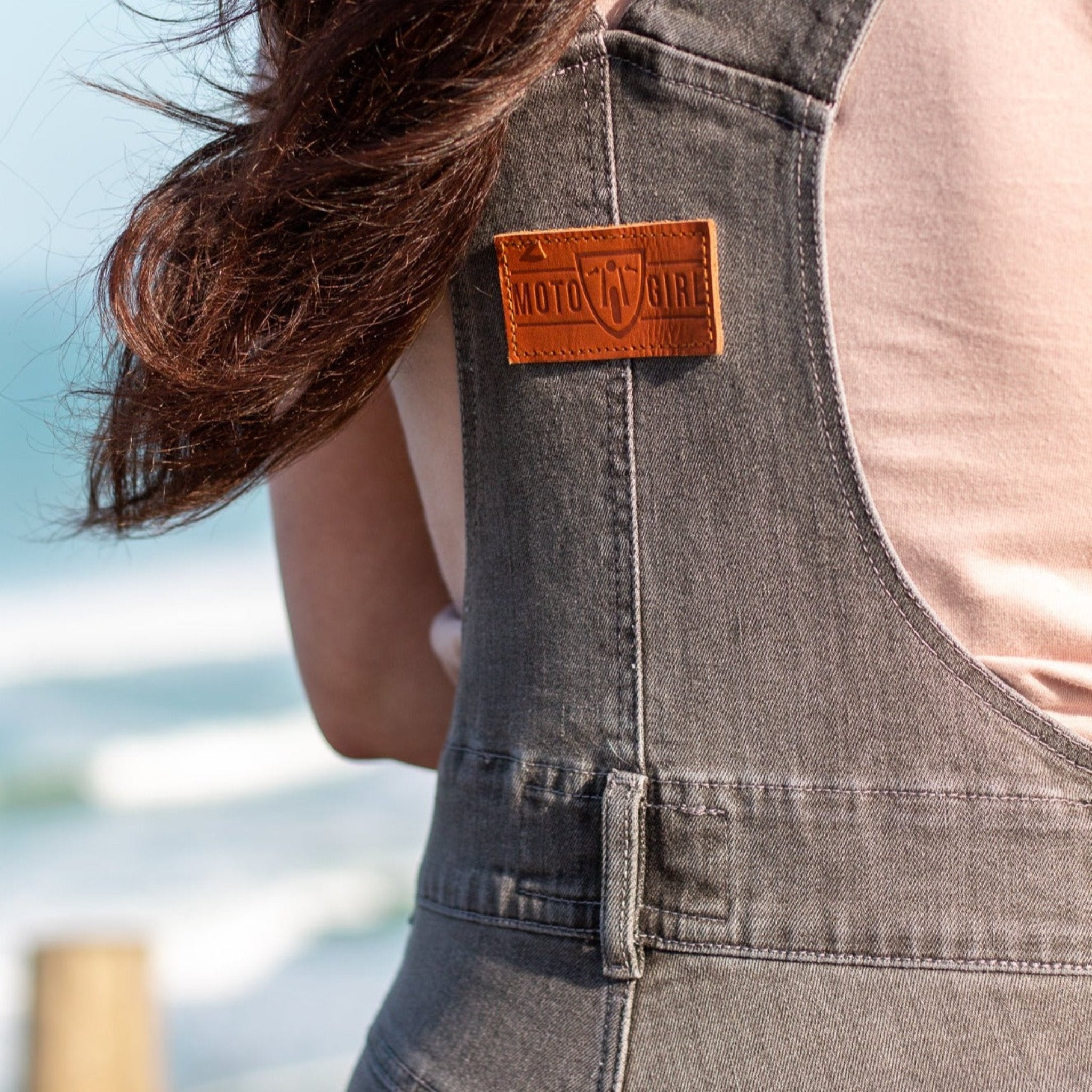 A close up of the Moto Girl patch on the back of women&#39;s motorcycle overall 