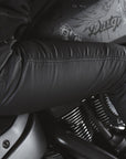 A woman on a motorcycle wearing women's black motorcycle jeans Lorica Kevlar from Pando Moto