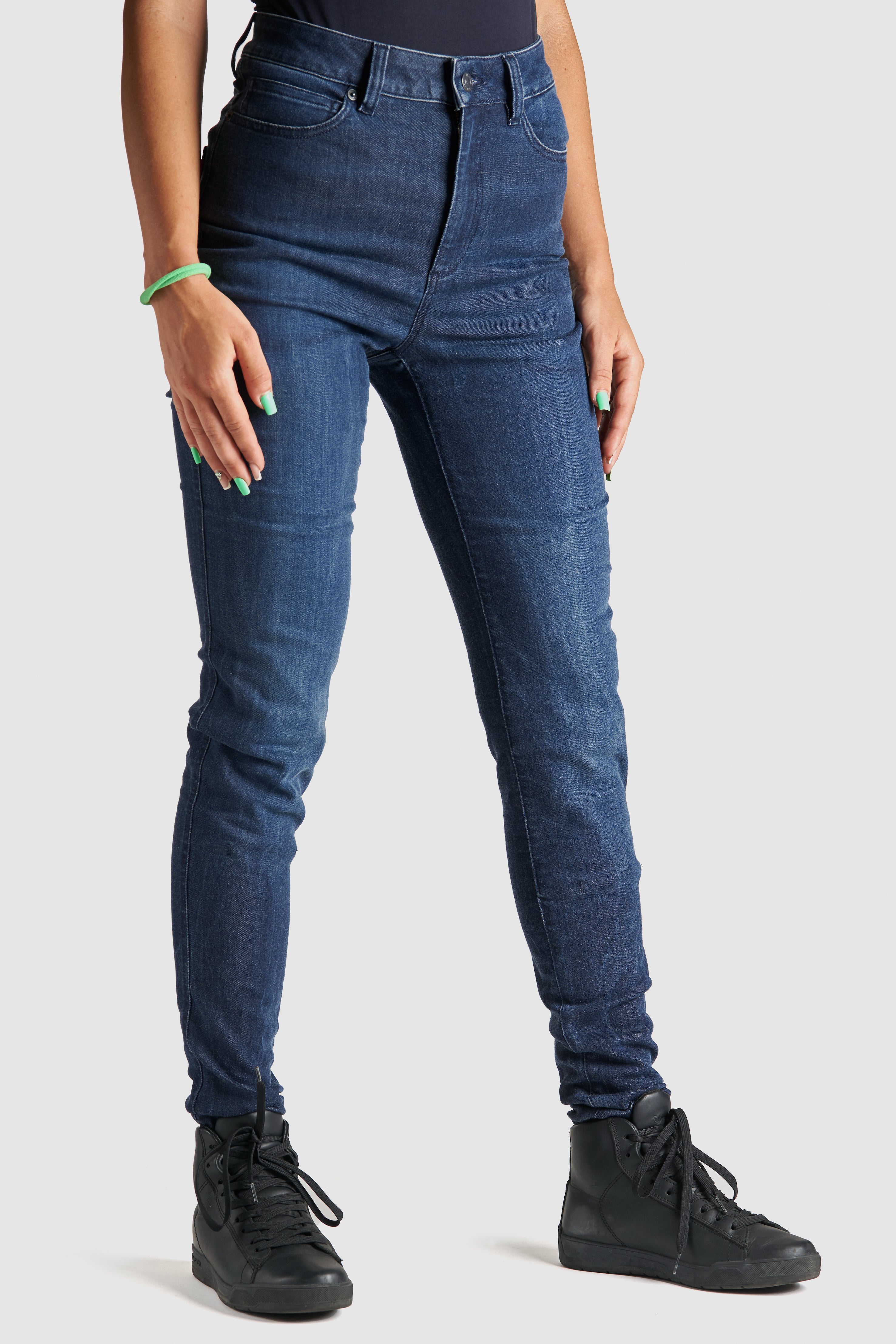 Woman&#39;s legs wearing blue motorcycle jeans 