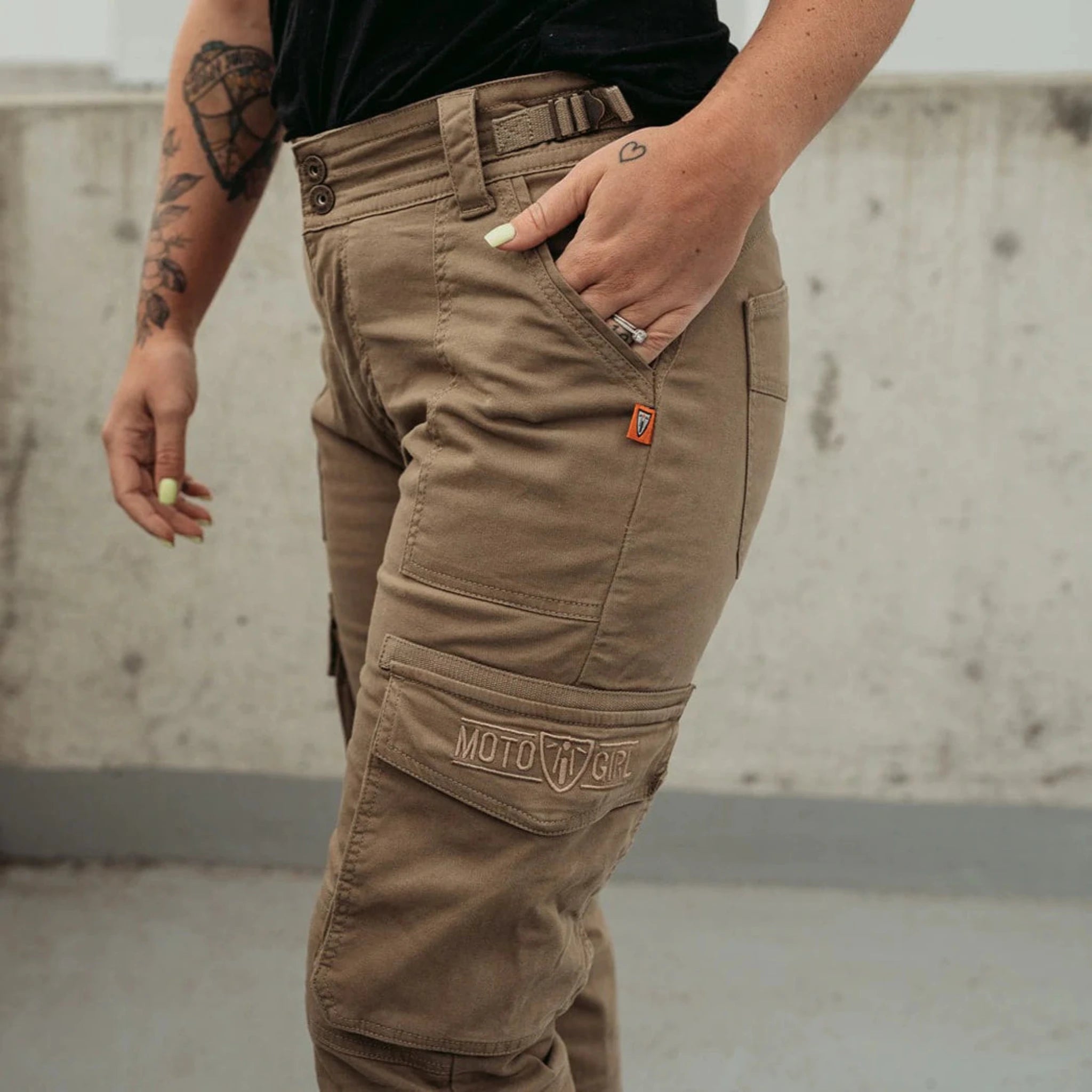 Woman&#39;s leg wearing beige motorcycle cargo pants from Moto Girl 