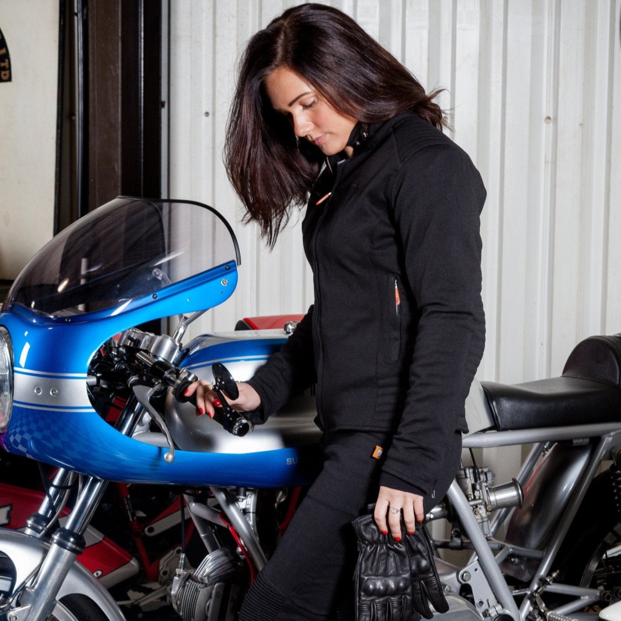 A woman standing by a motorcycle wearing women&#39;s motorcycle clothes from MotoGirl 