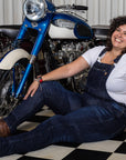 A woman siting by the motorcycle wearing Blue kevlar motorcycle overall for women from Motogirl