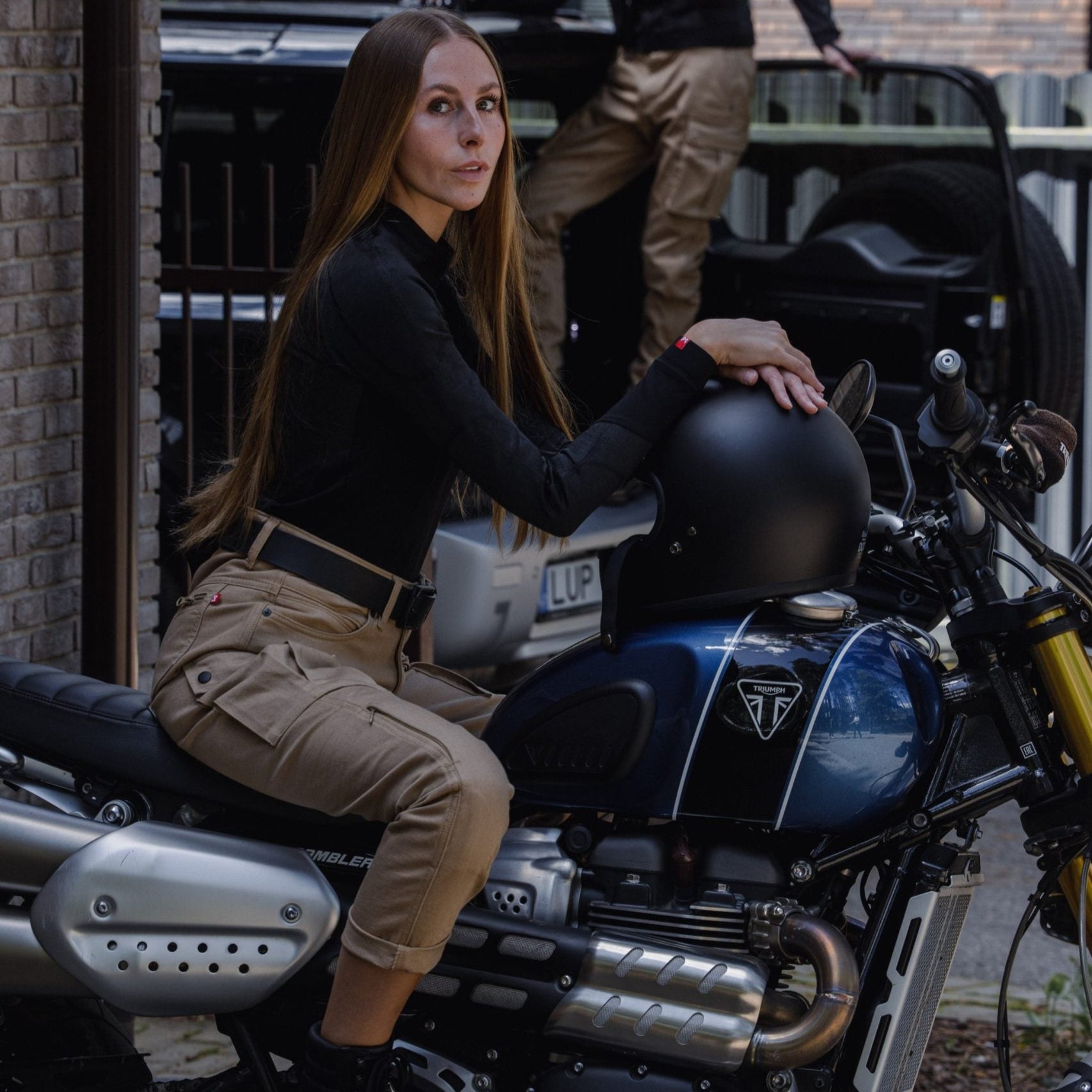 a woman on her motorcycle wearing beige mc pants 