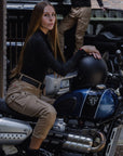 a woman on her motorcycle wearing beige mc pants 