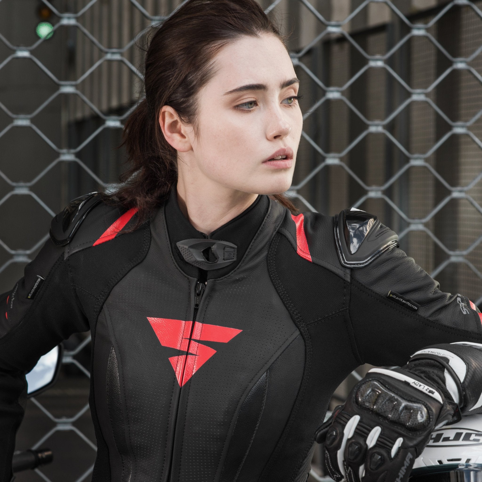 A young woman wearinh Black and red women&#39;s motorcycle racing suit from Shima