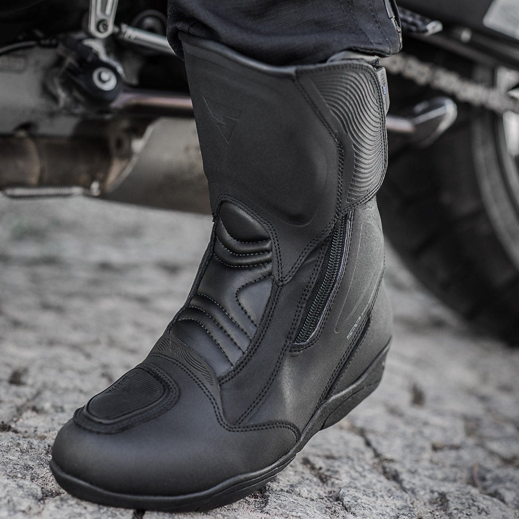 Woman's foot with a black women's motorcycle touring boot from Shima