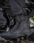 Woman's foot on a motorcycle with a black women's motorcycle touring boot from Shima