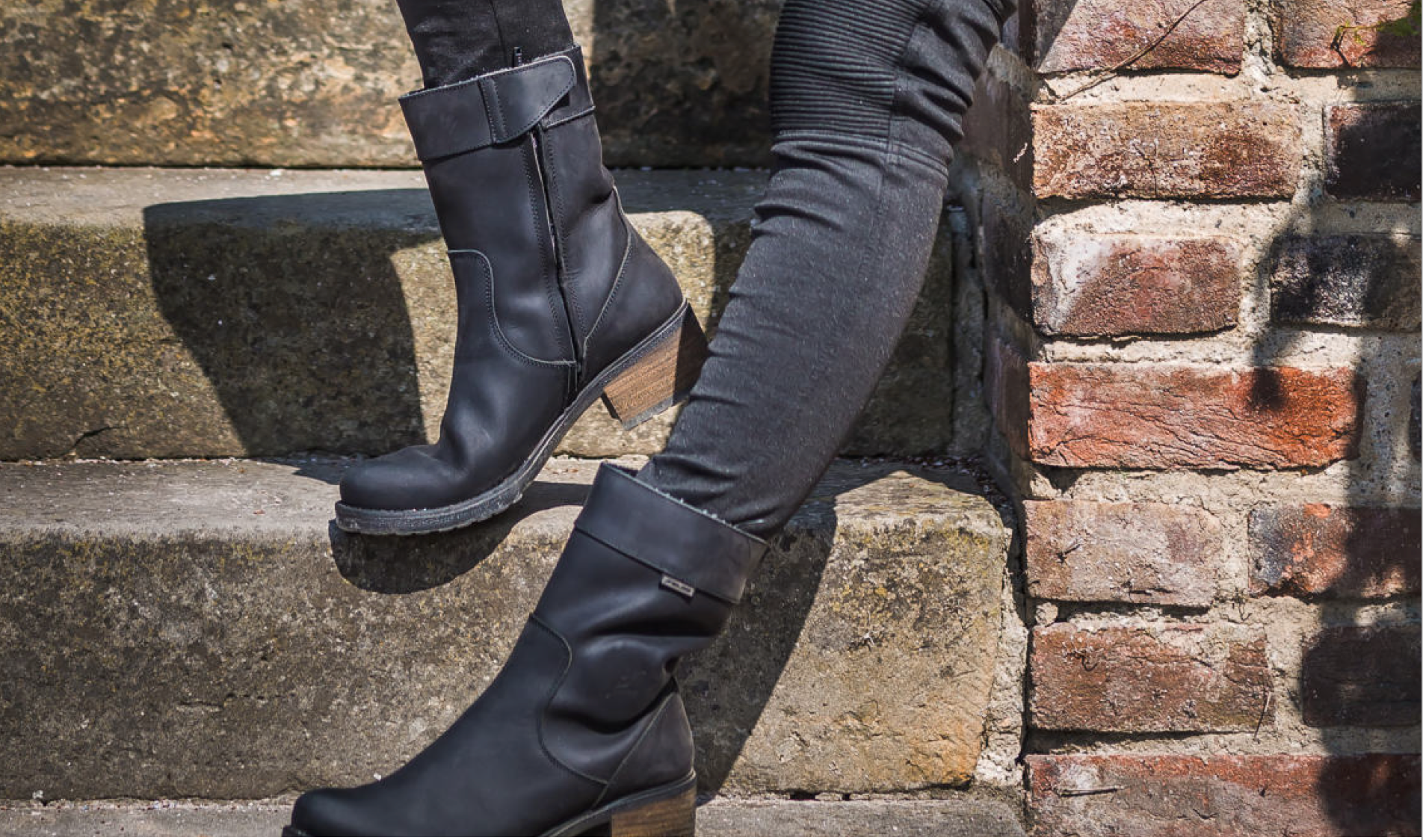 Woman&#39;s legs wearing black women&#39;s motorcycle boots from Falco 