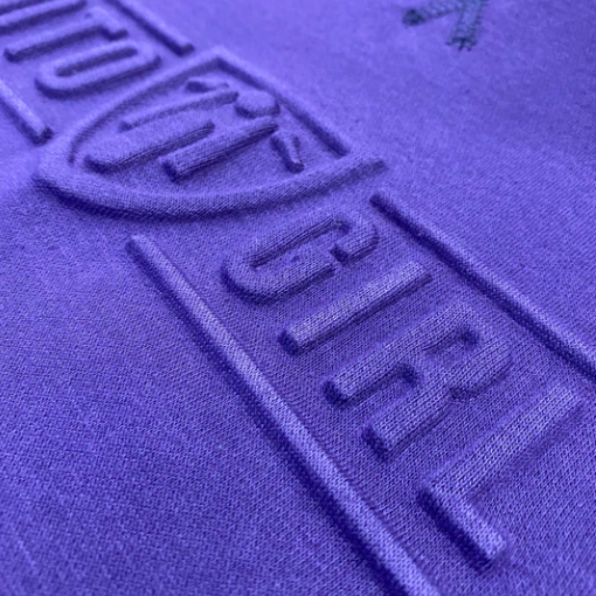 A close up of the 3d logo on a women's motorcycle sweatshirt from Moto Girl in the color purple 