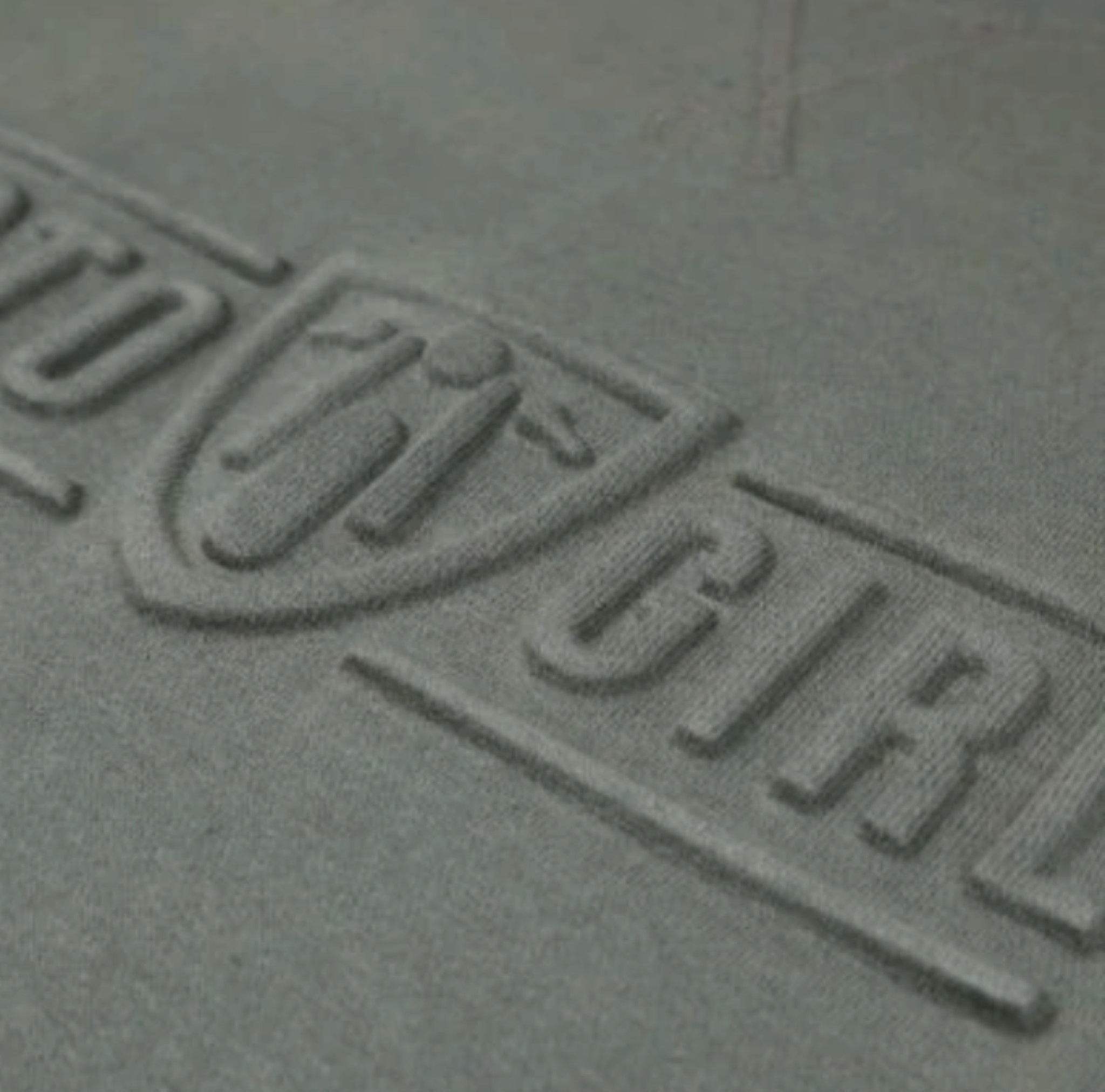 A close up of the 3d logo on a women&#39;s motorcycle sweatshirt from Moto Girl in the color olive green 