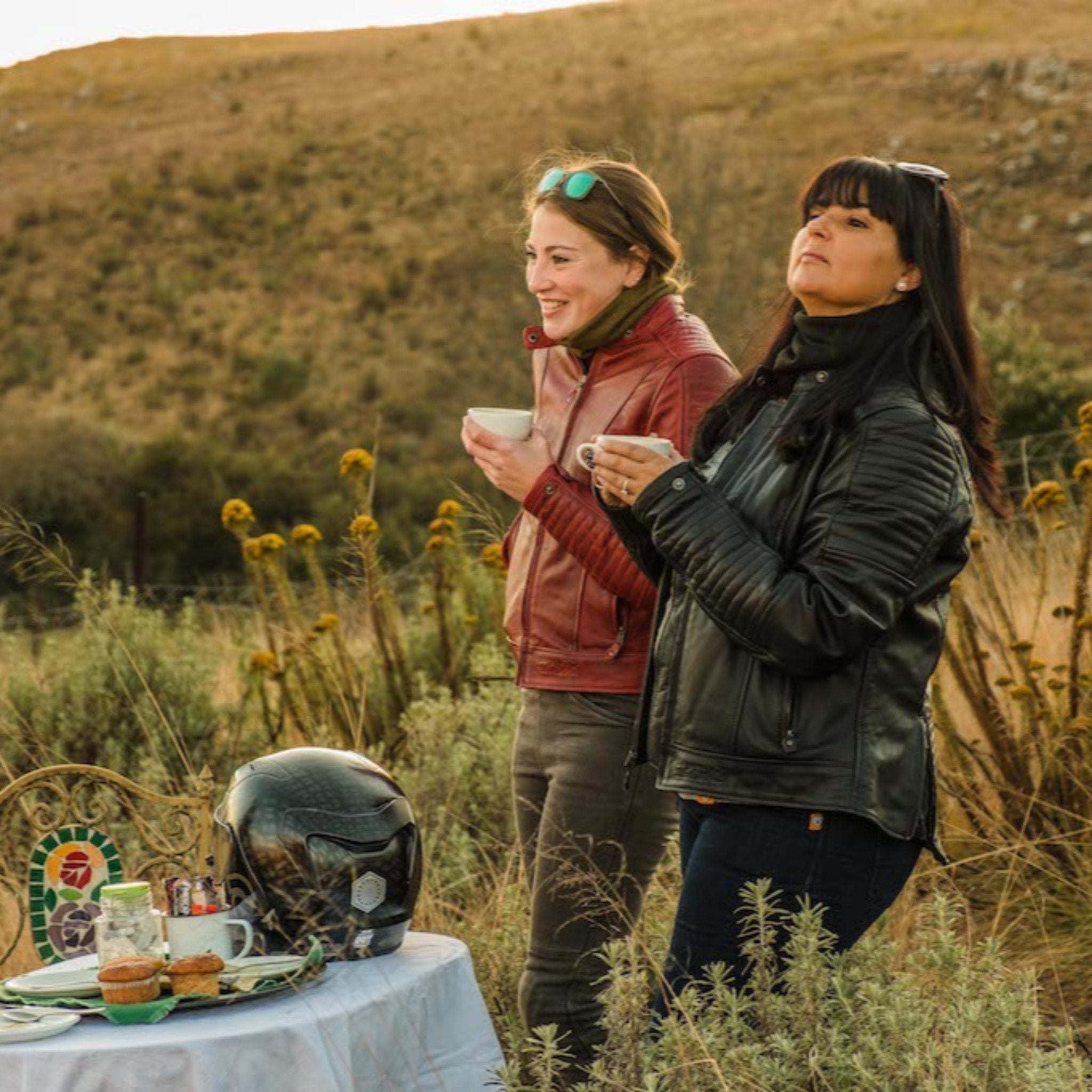 Women having coffee on a motorcycle trip wearing Valerie motorcycle leather jacket from Moto Girl