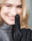 a woman's finger wearing black motorcycle glove with touch pad panel