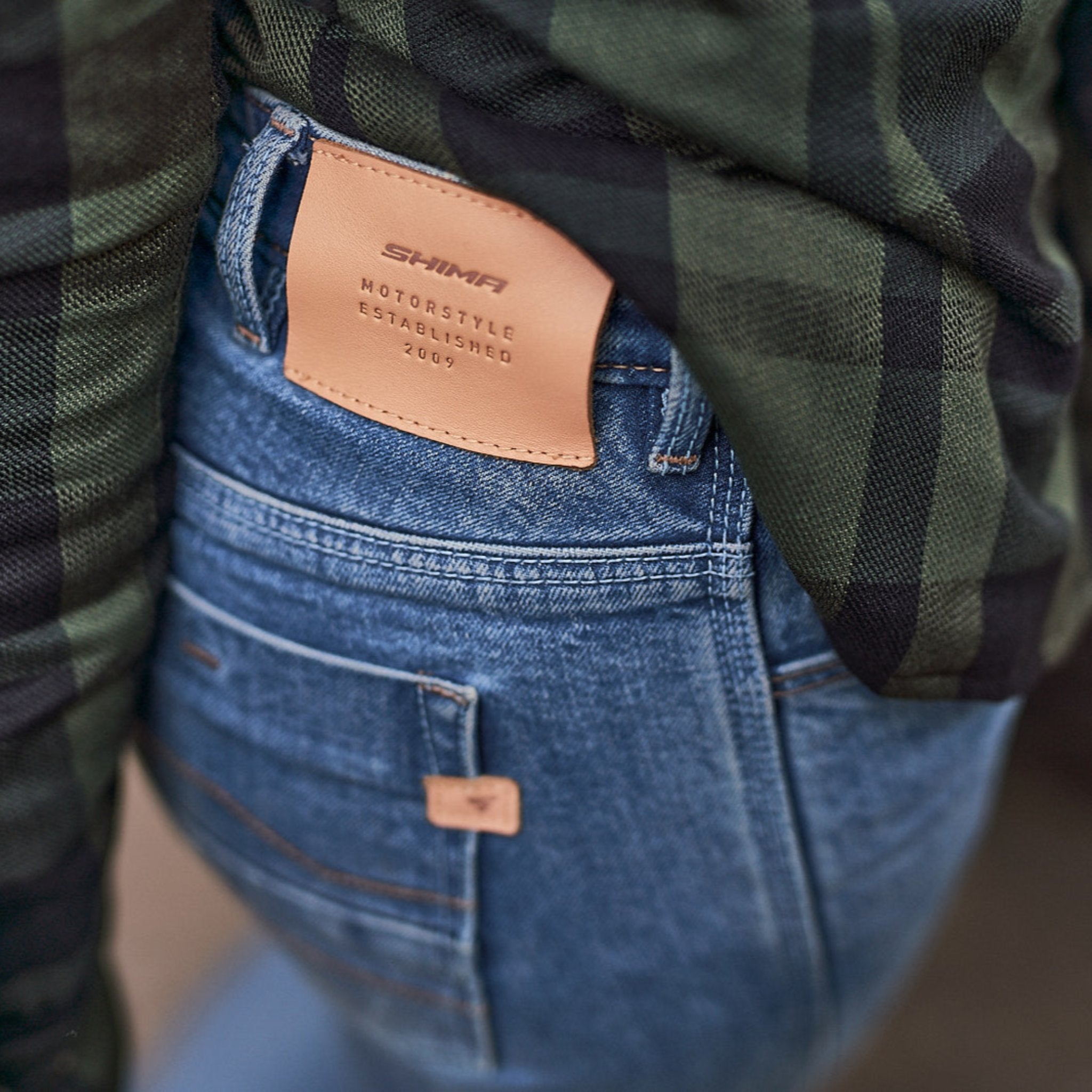 A close up of the patch on blue motorcycle jeans