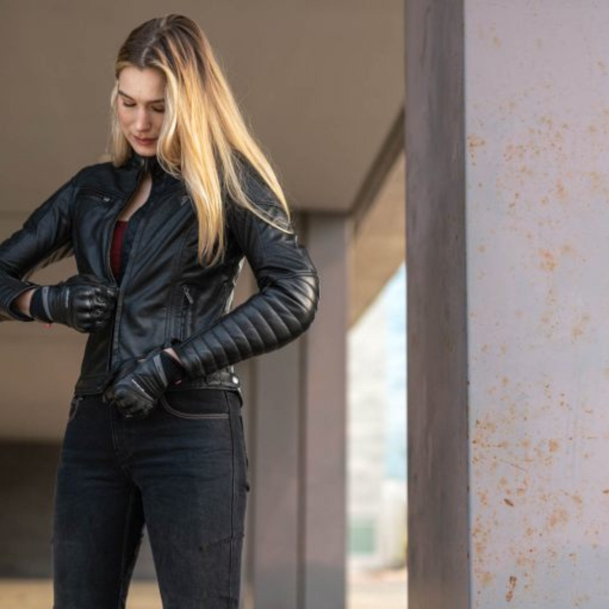 A blond woman wearing Black leather motorcycle jacket for women from Shima