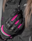 A close up of a woman's hand wearing Black and pink women's motorcycle gloves Rush lady  from Shima