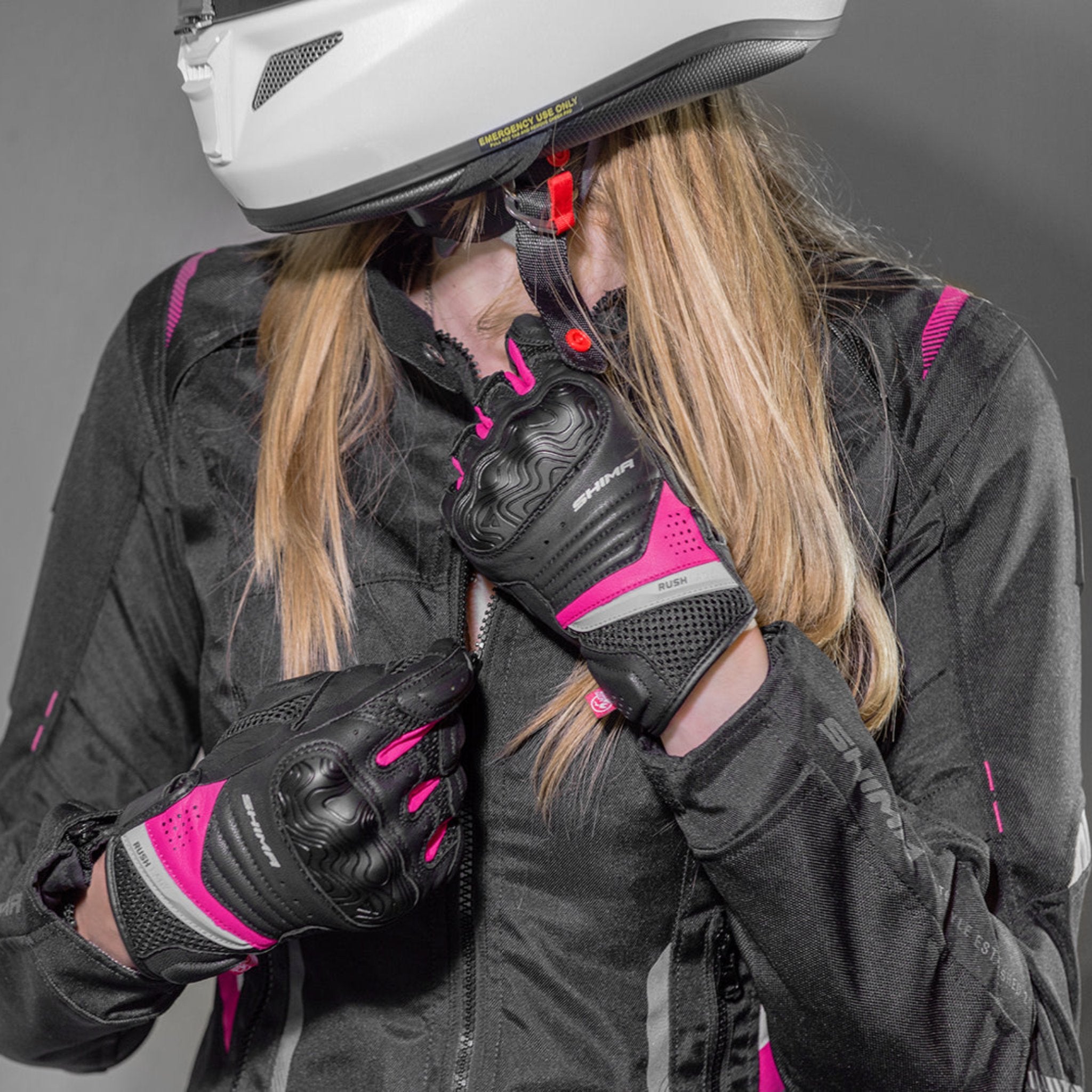 a woman zipping her jacket wearinh Black and pink women's motorcycle gloves Rush lady  from Shima