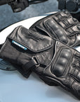  black waterproof motorcycle gloves on a white motorcycle  tank 